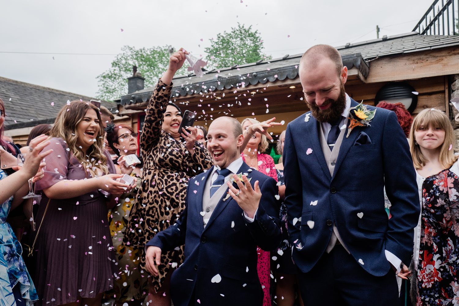 Gay wedding - two grooms in shower of confetti Gay wedding - two grooms in shower of confetti