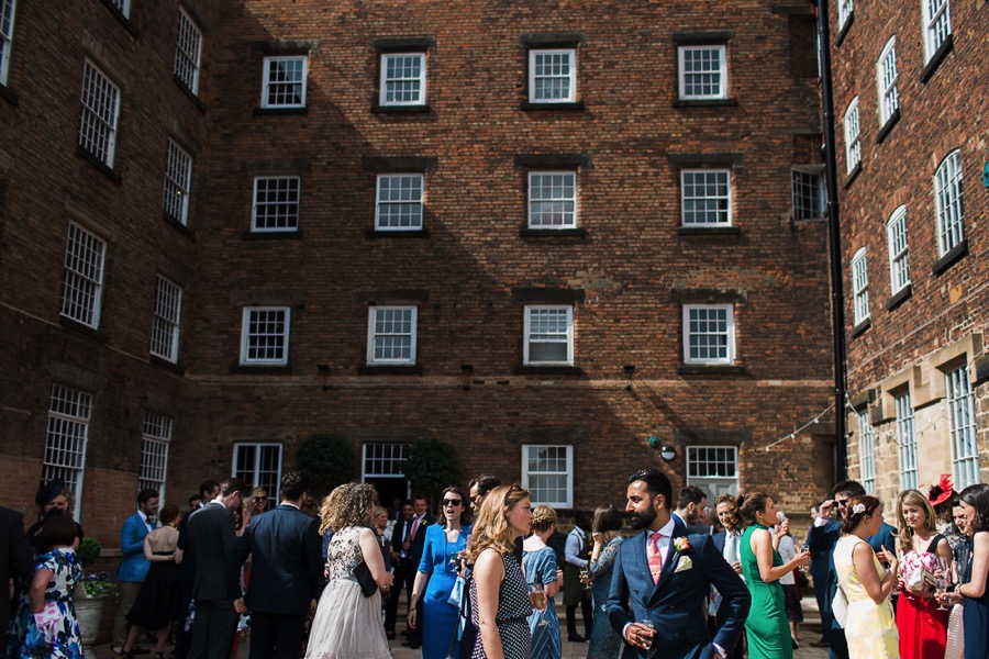 Wedding Guests Mingle in The West Mill Courtyard Wedding Guests Mingle in The West Mill Courtyard