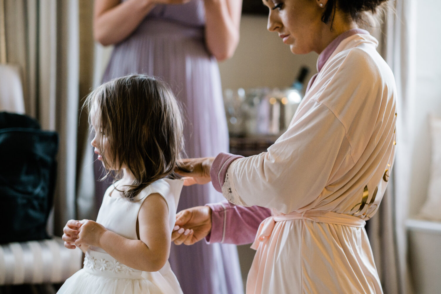 Eyam Hall Wedding Photographer 4 Bride doing flower girl hair