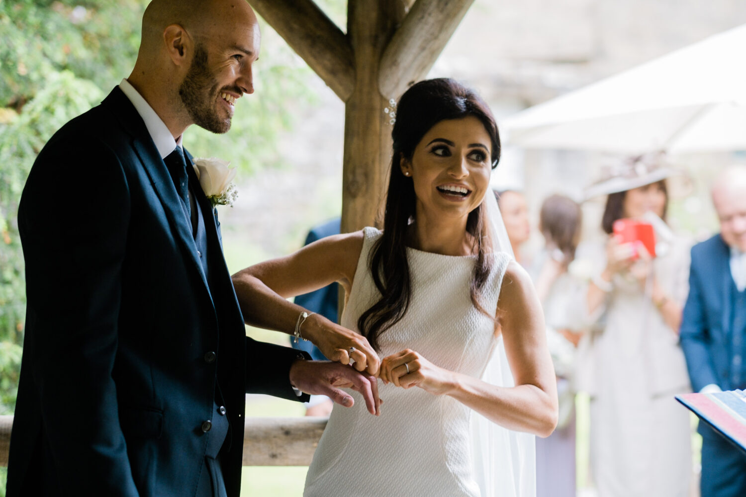 Eyam Hall Wedding Photographer 11 Bride and groom putting on ring Eyam Hall