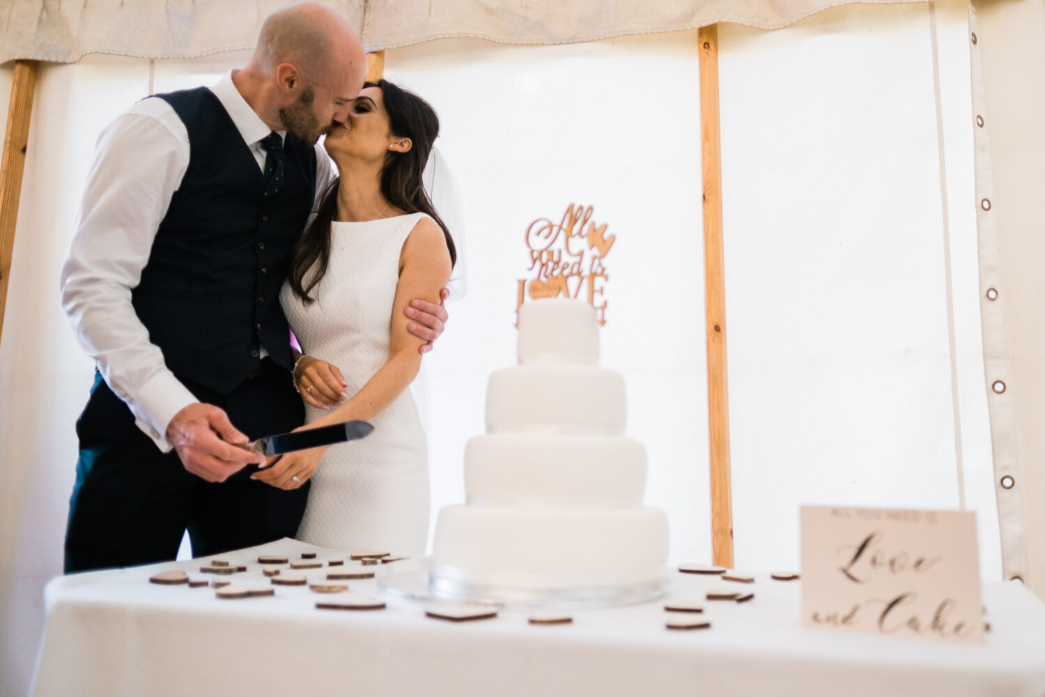 Eyam Hall Wedding Photographer 25 Bride and Groom Cutting the cake at Eyam Hall