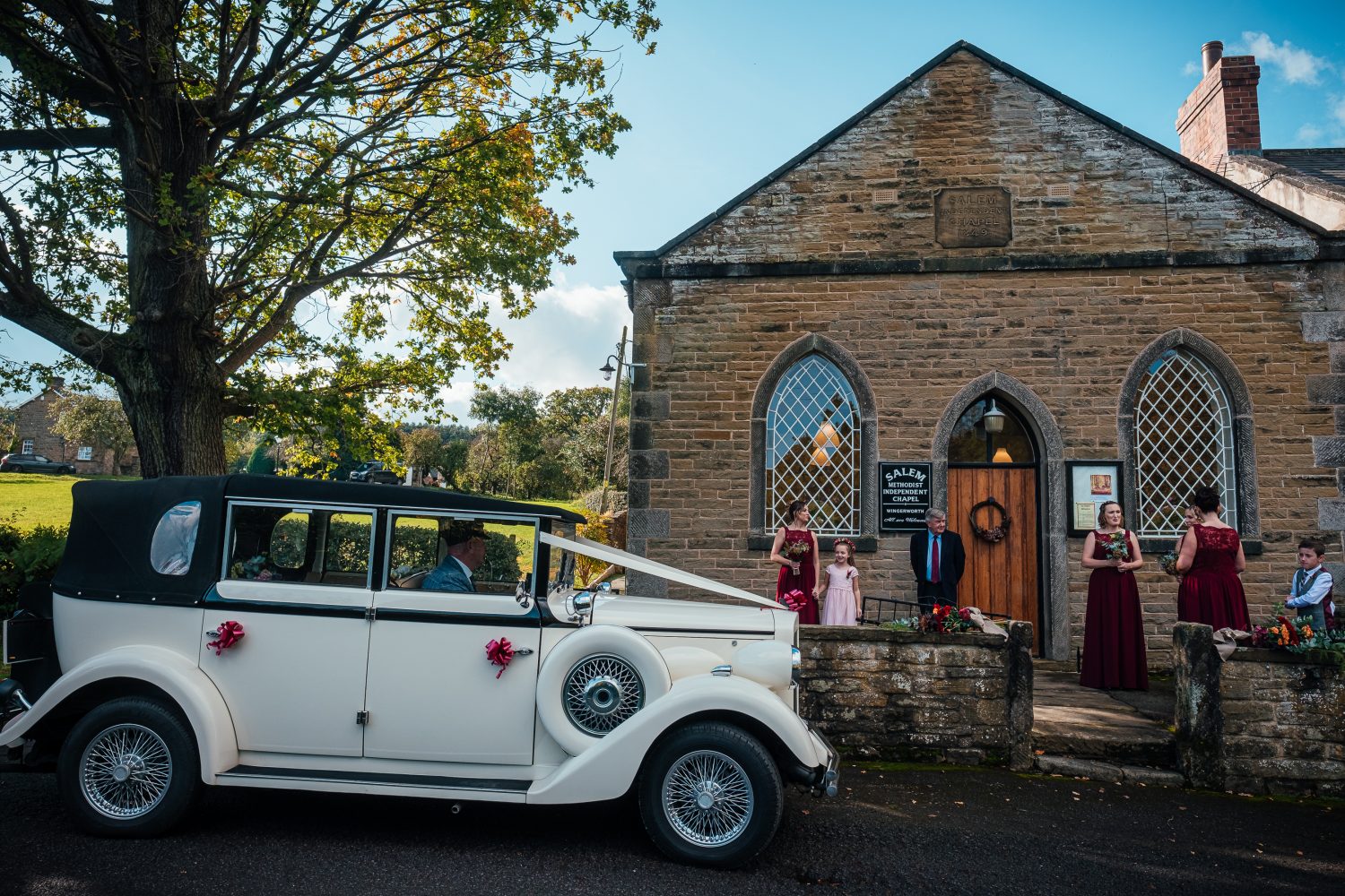 Bride arrives, classic car