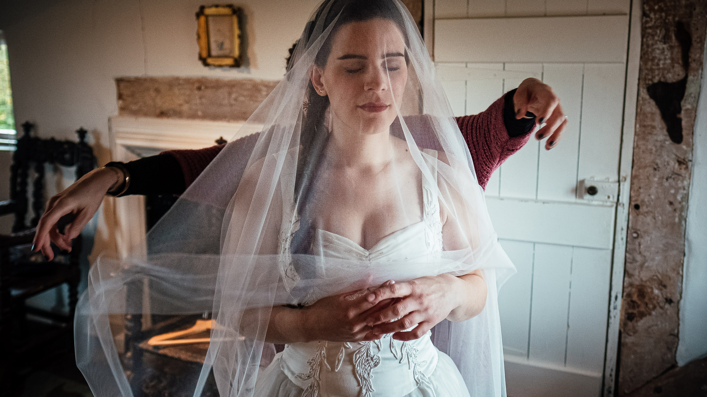 Bride having her veil arranged on hte wedding morning Documentary wedding photography by Simon Dewey