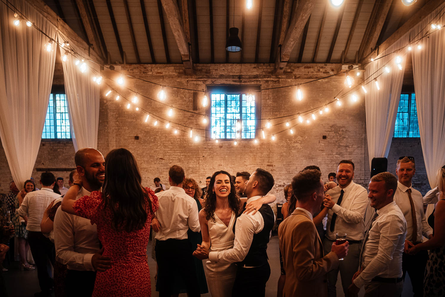 Bride and Groom and guests dancing at Calke Abbey Riding School Wedding