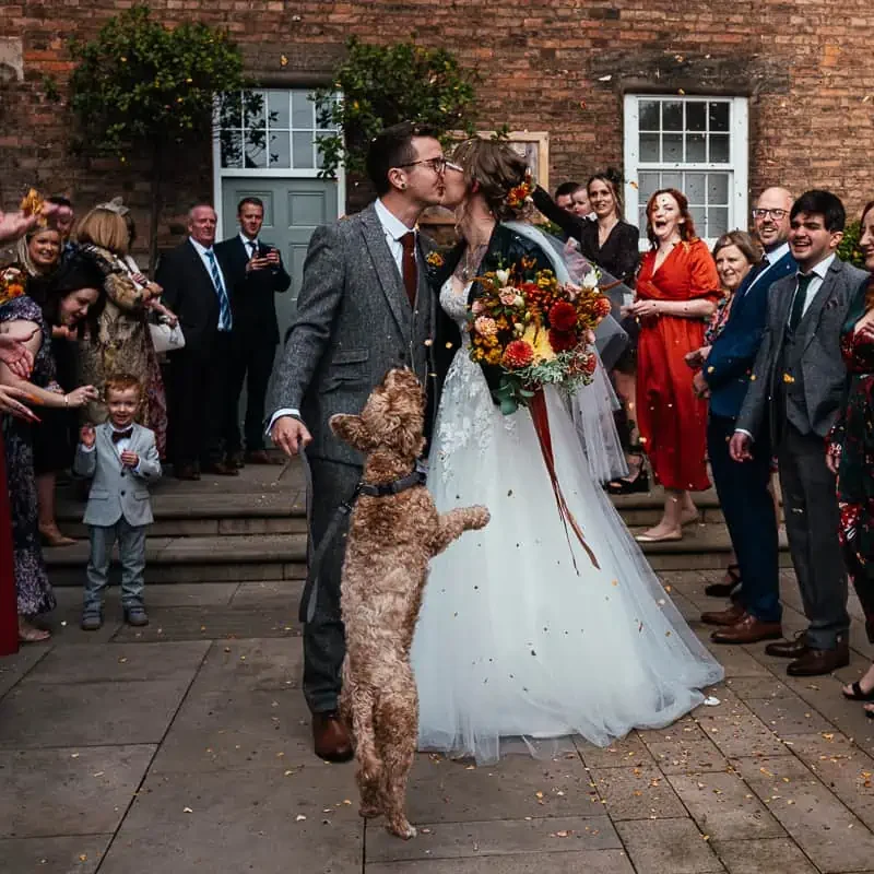 Guests throw Confetti Outside The West Mill Exclusive Use Wedding Venue