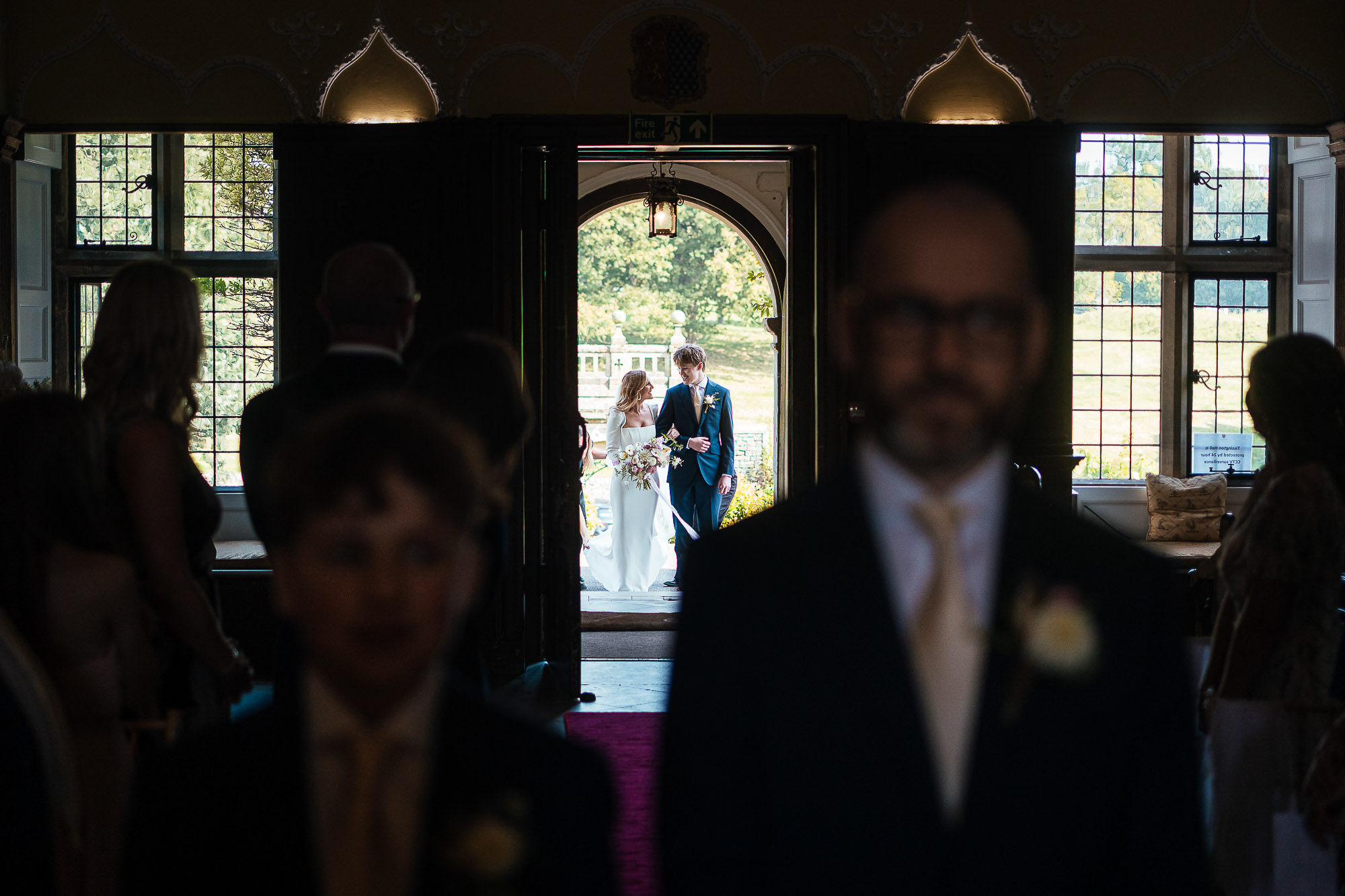 Best Documentary wedding photography Bride and son wait at the top of the aisle at Tissington Hall Documentary Wedding Photographer