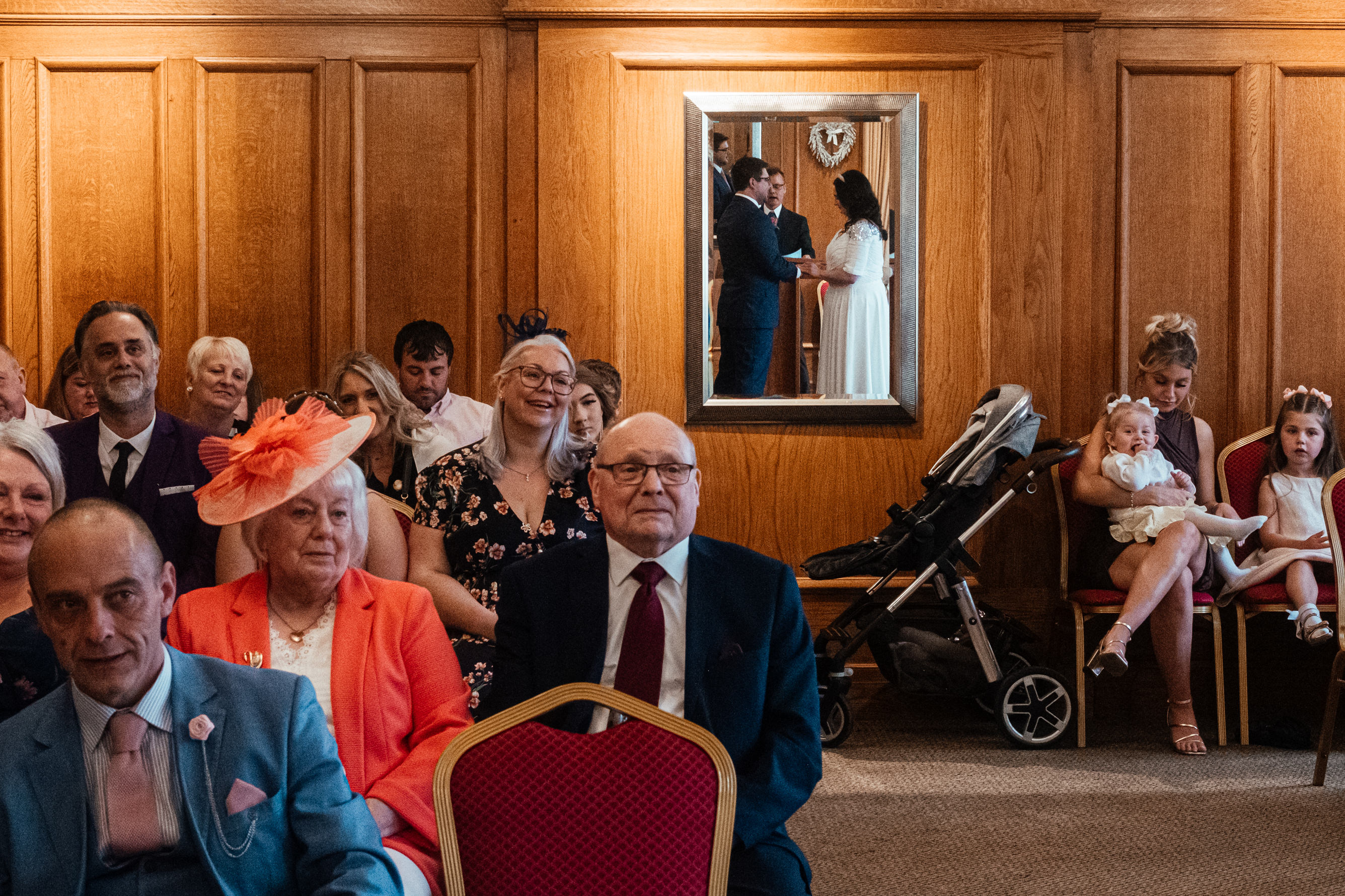 Wedding Photography Mentoring 8 Mansfield Registry Office Wedding Ceremony. Artistic shot of couple caught in mirror whilst saying their vows. Documentary, reportage, street style wedding photography.