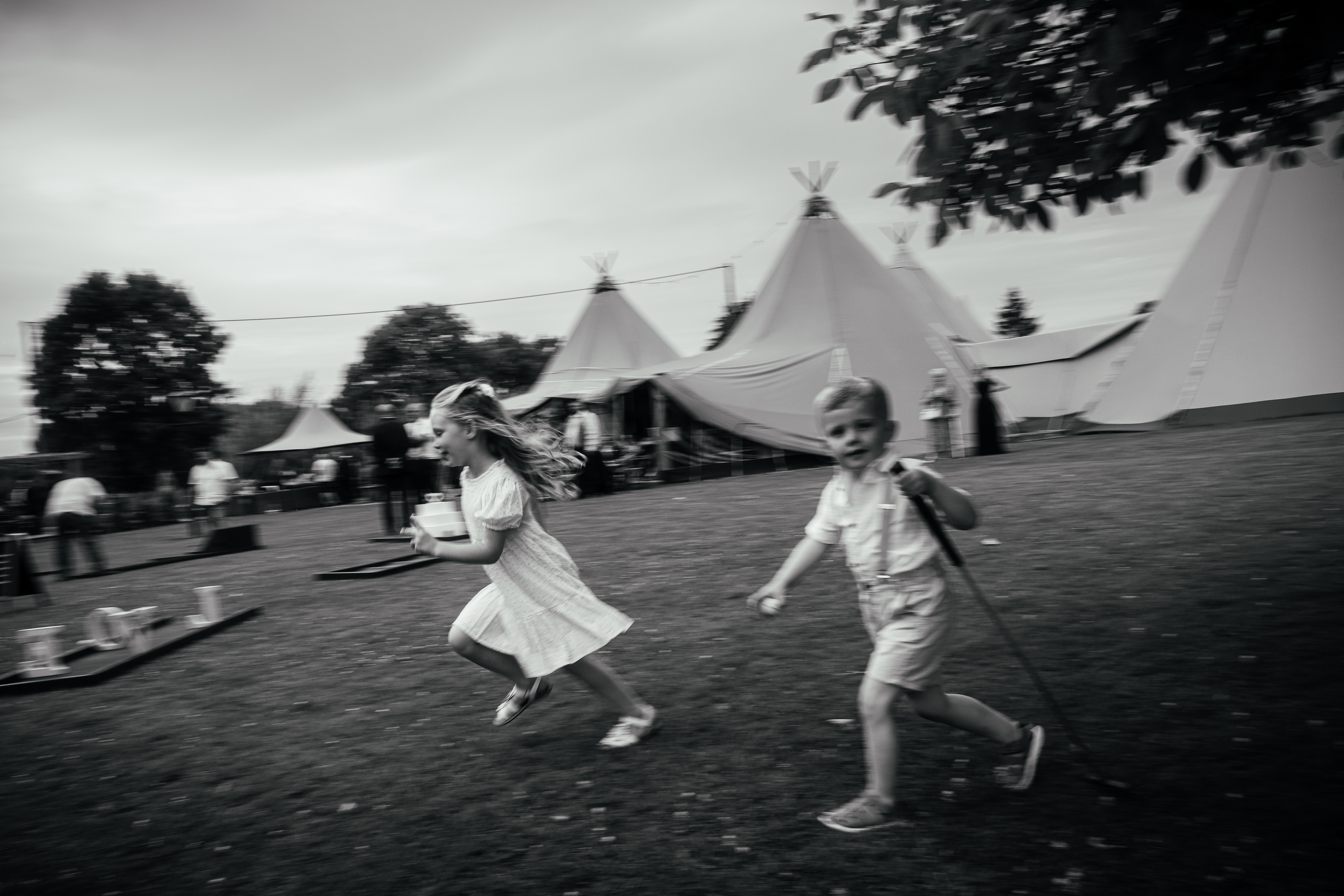 Wedding Photography Mentoring 6 Blurry, artistic black and white, grainy image of children playing at a wedding. Documentary reportage photojournalism